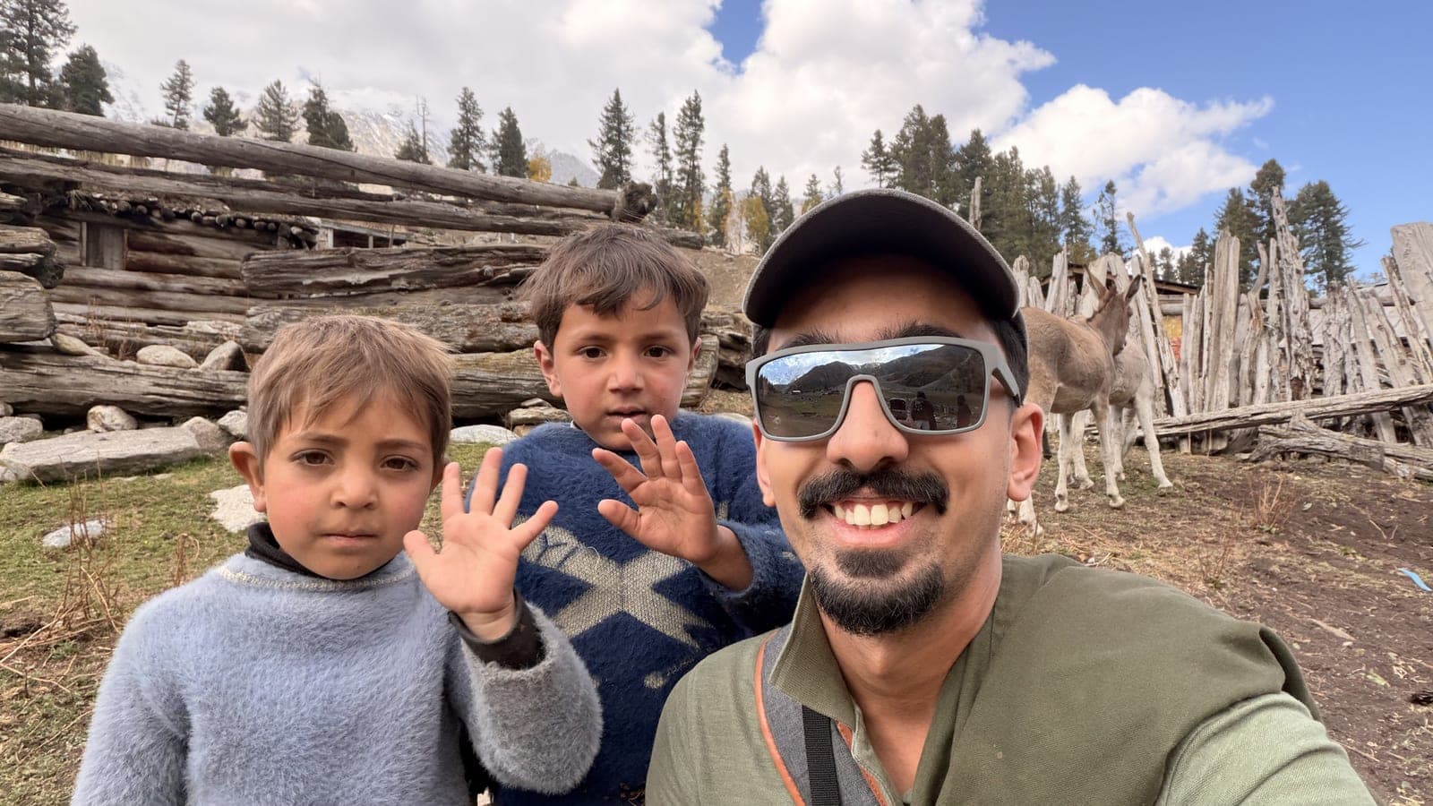 Sarib in sunglasses with two children at a hilltop viewpoint