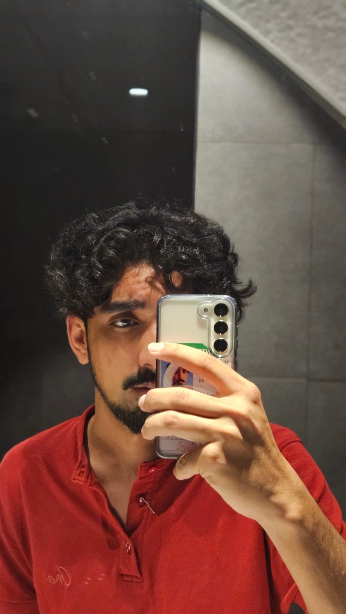 Sarib taking a mirror selfie with his phone