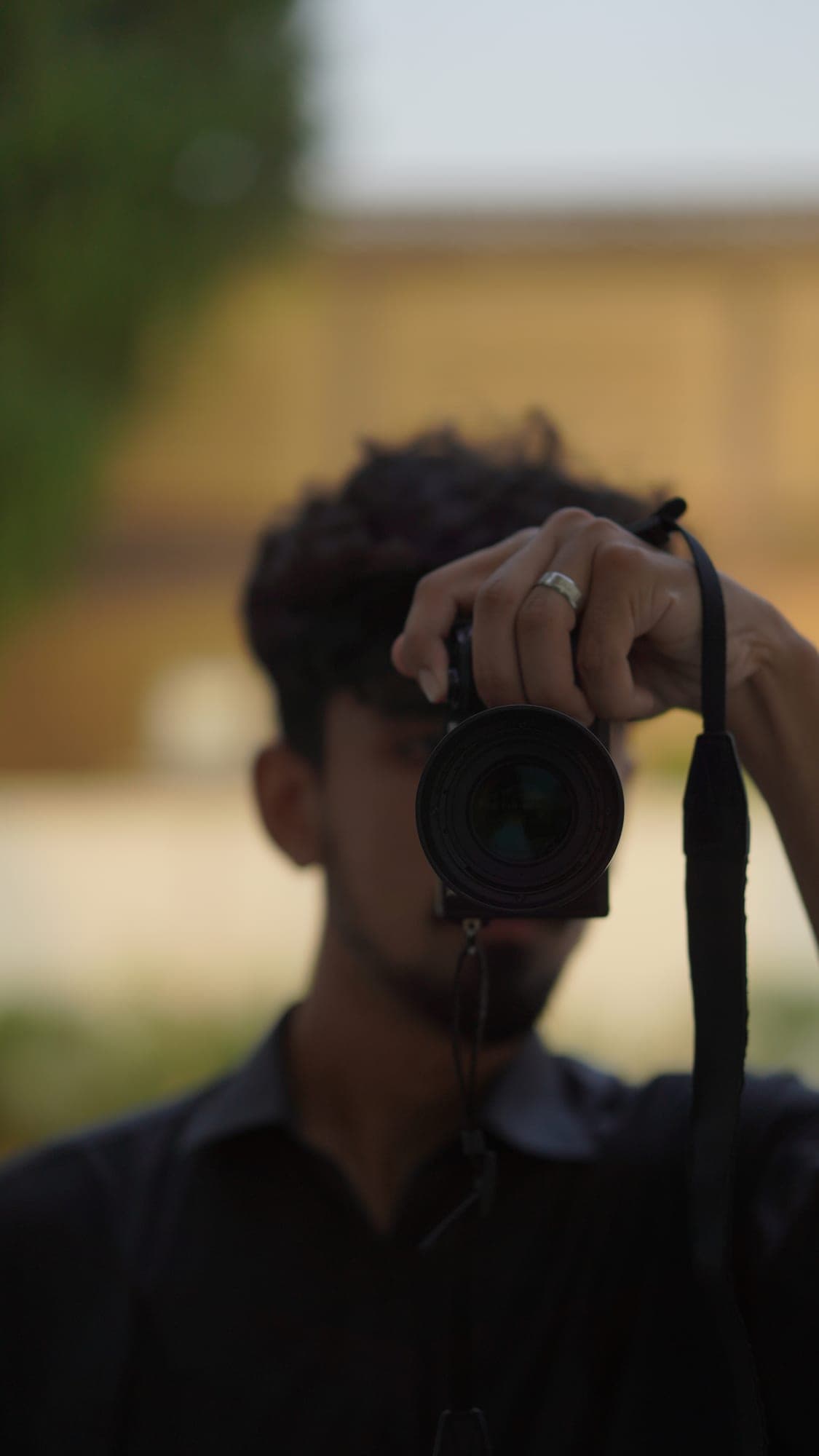 A photographer raising a camera to his eye
